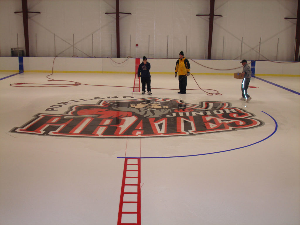 Portland Pirates logo being painted on the ice